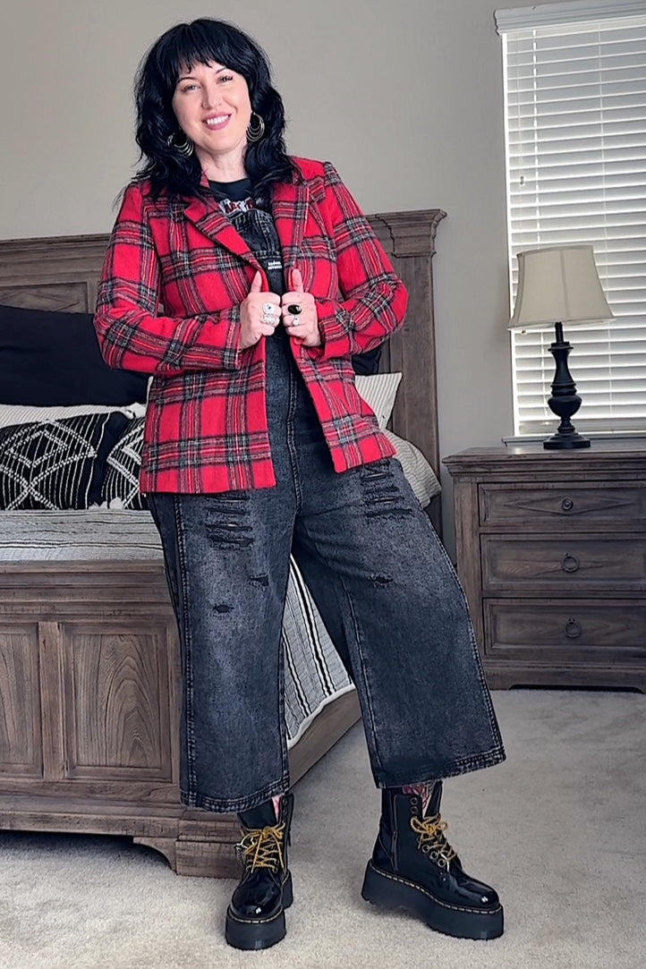Person wearing a red plaid jacket in a bedroom setting