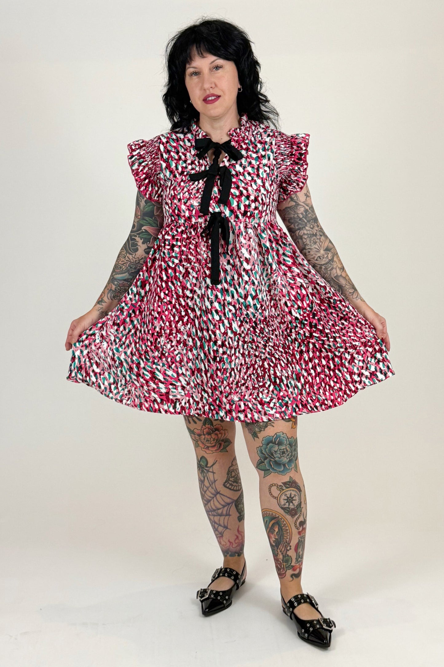 women in pink leopard dress