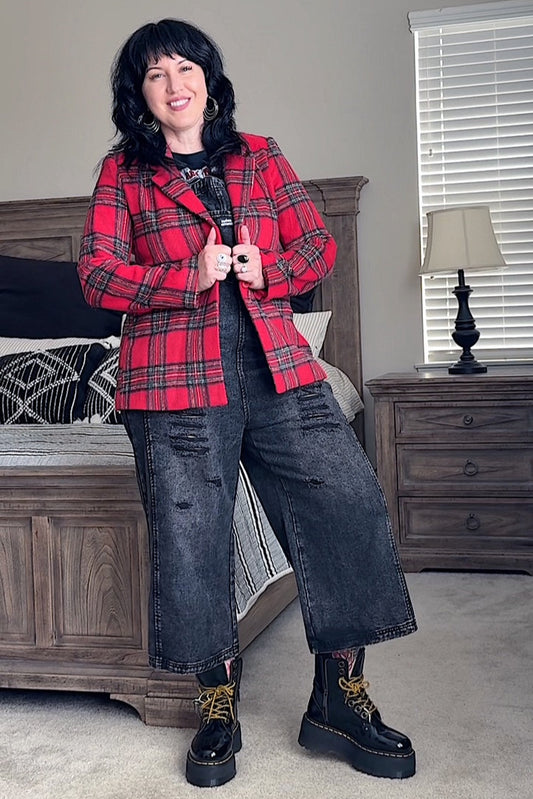 Person wearing a red plaid jacket in a bedroom setting