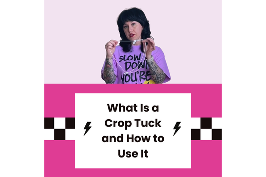 Fashion stylist demonstrating a crop tuck technique using an elastic cord to create a cropped silhouette with an oversized t-shirt