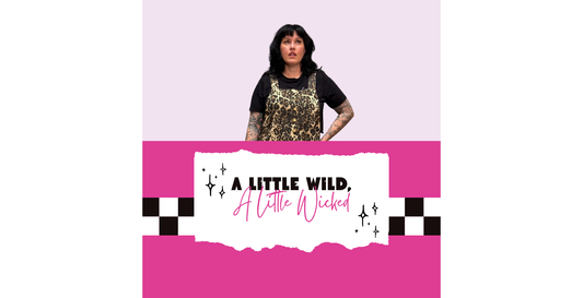 Rachel Nevarez A Little Wild, A Little Wicked blog cover featuring a woman wearing leopard print overalls over a black tee, with a bright pink background, checkerboard accents, and bold typography.