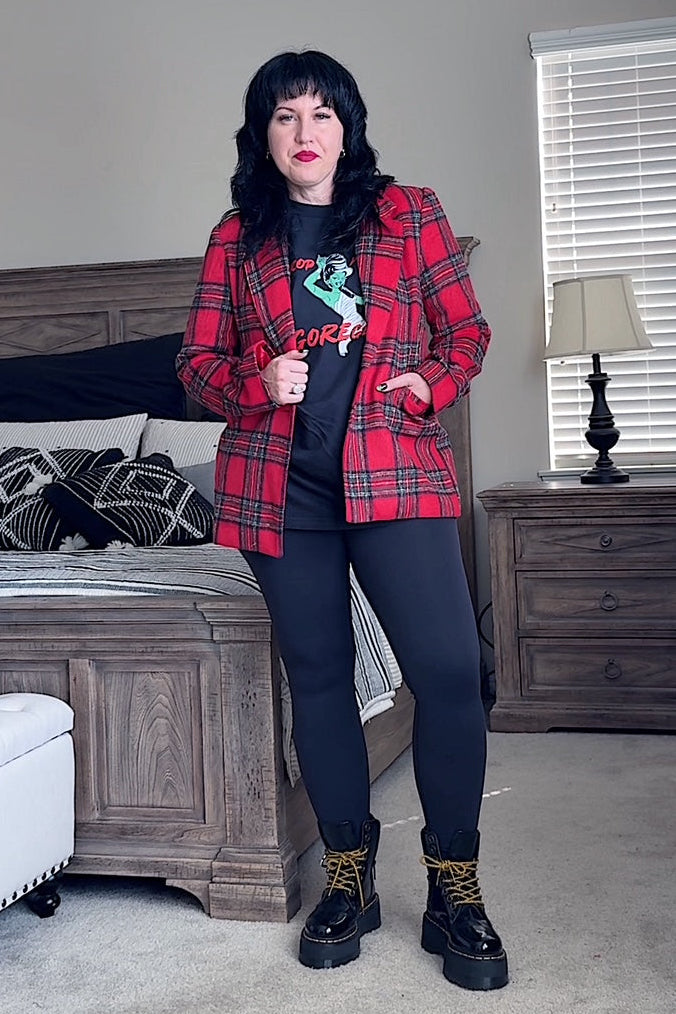 Person wearing a red plaid jacket in a bedroom setting