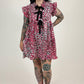 women in pink leopard dress