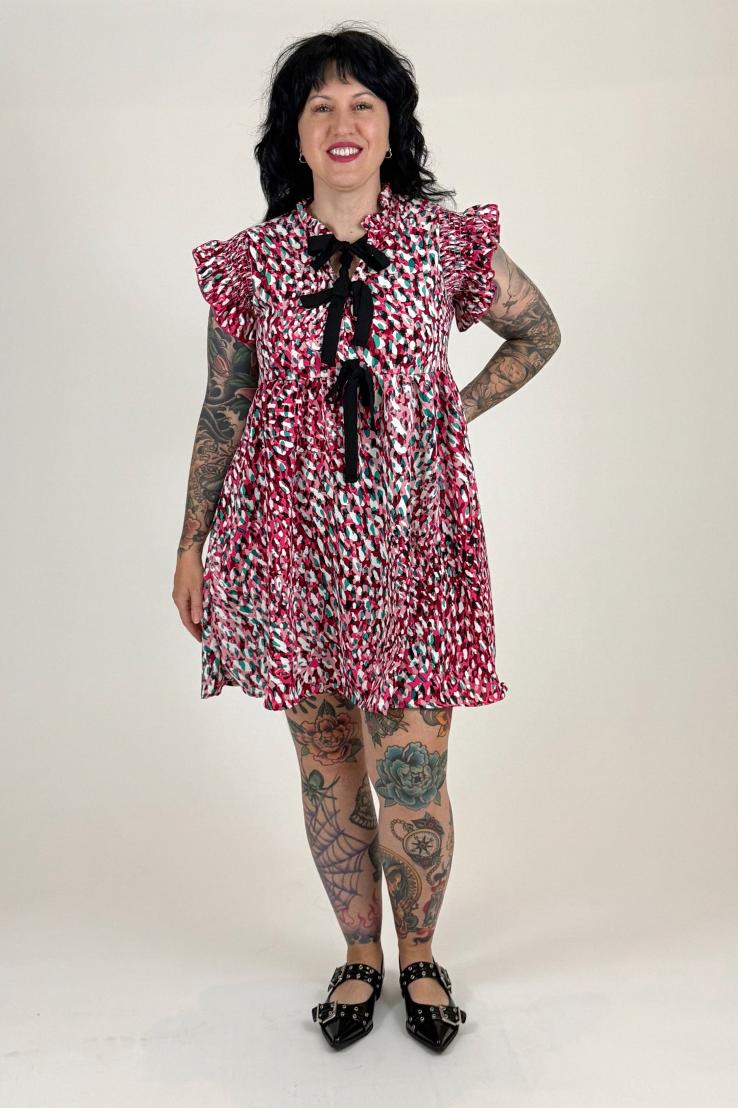 women in pink leopard dress