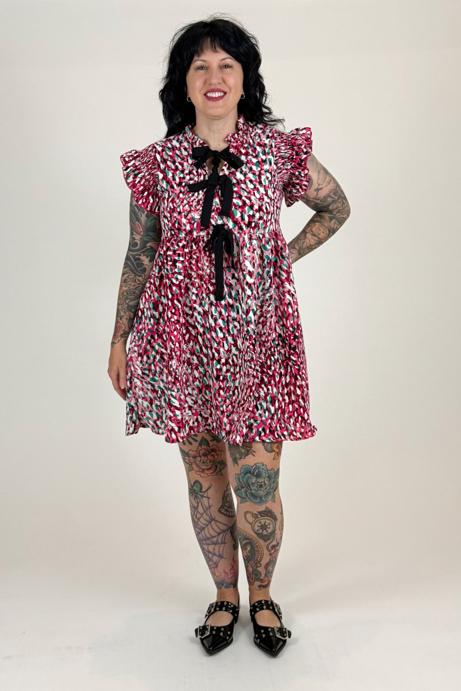 women in pink leopard dress