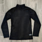 Black ribbed long-sleeve shirt on a wooden floor