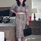 Women standing in bedroom wearing fitted rib knit leopard print pencil skirt matching top, sandals, hot, and holding a purse