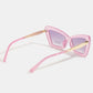 Pink cat-eye sunglasses with gold accents on a white background