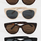 Four pairs of cat-eye sunglasses with different frame colors on a white background.