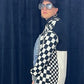 woman in sunglasses wearing overalls and black and white checkered cardigan