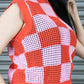 Person wearing a red and pink checkered sleeveless top with a leopard print skirt.