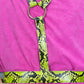 Person wearing a pink shirt with a yellow and black snake pattern harness.
