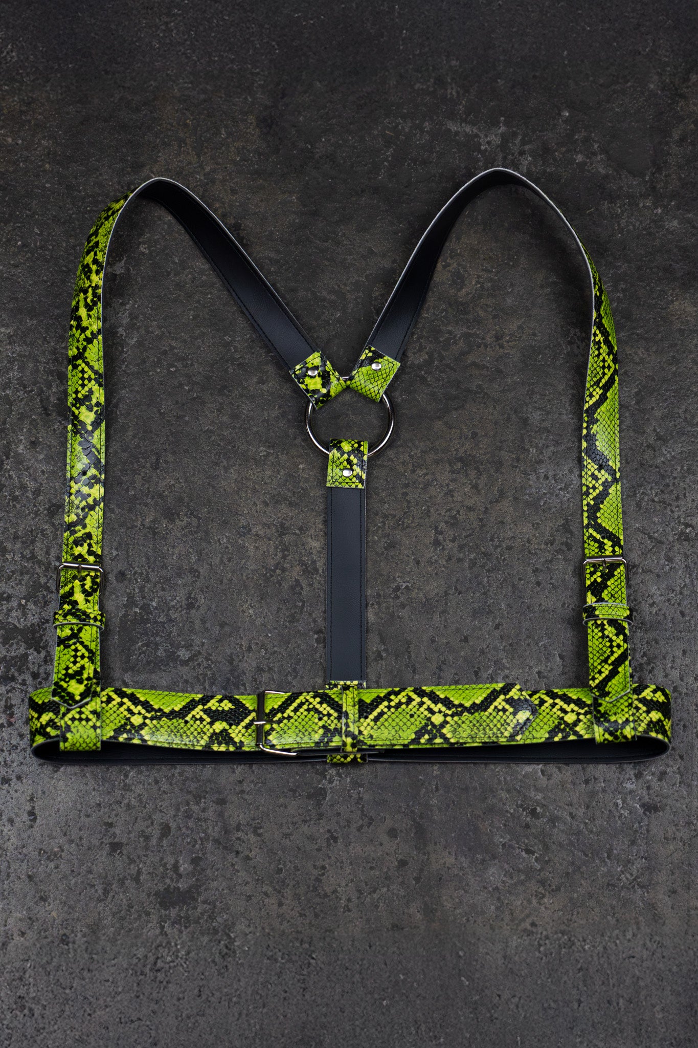 Green snake print harness on a dark gray background