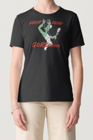 Woman wearing a black t-shirt with graphic design and text on a plain background
