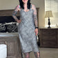 Woman in a patterned dress standing in a bedroom