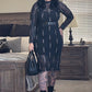 Person wearing a black dress with sheer panels in a living room setting