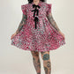 women in pink leopard dress