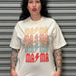 Person wearing a white t-shirt with colorful text and graphics against a gray background