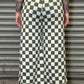 Person wearing a green and white checkered skirt against a metallic shutter background