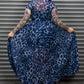 Person wearing a blue leopard print dress in front of a metal shutter.