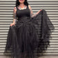 Woman holding a black sheer overlay against a metal shutter background