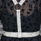 Black dress with a leopard print pattern and a white harness.