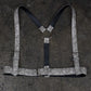 White harness with a decorative pattern on a dark textured background
