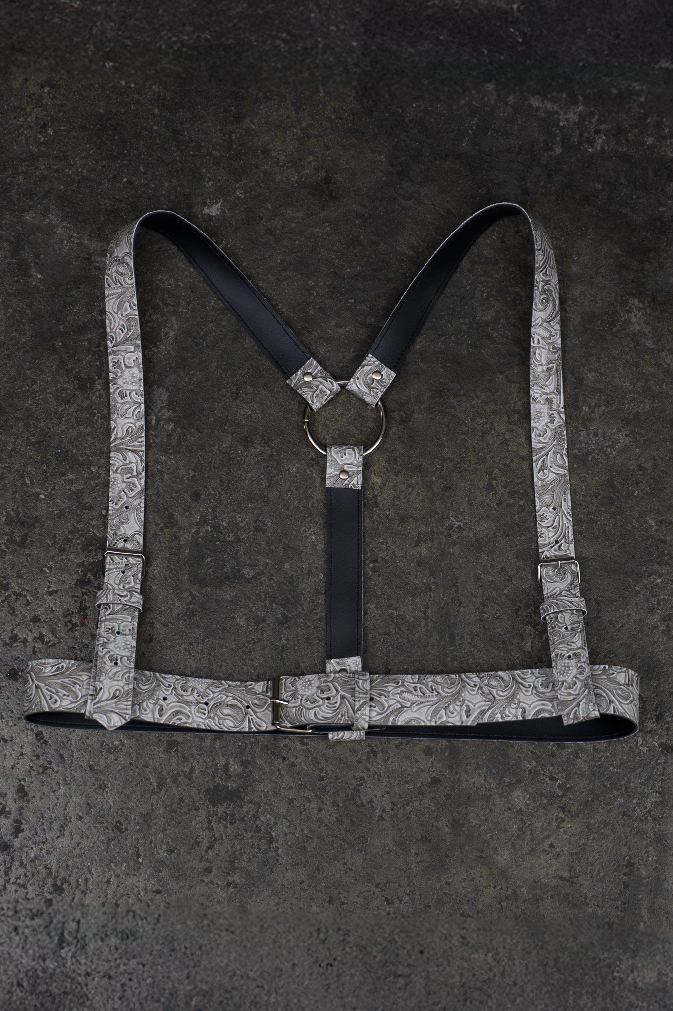 White harness with a decorative pattern on a dark textured background