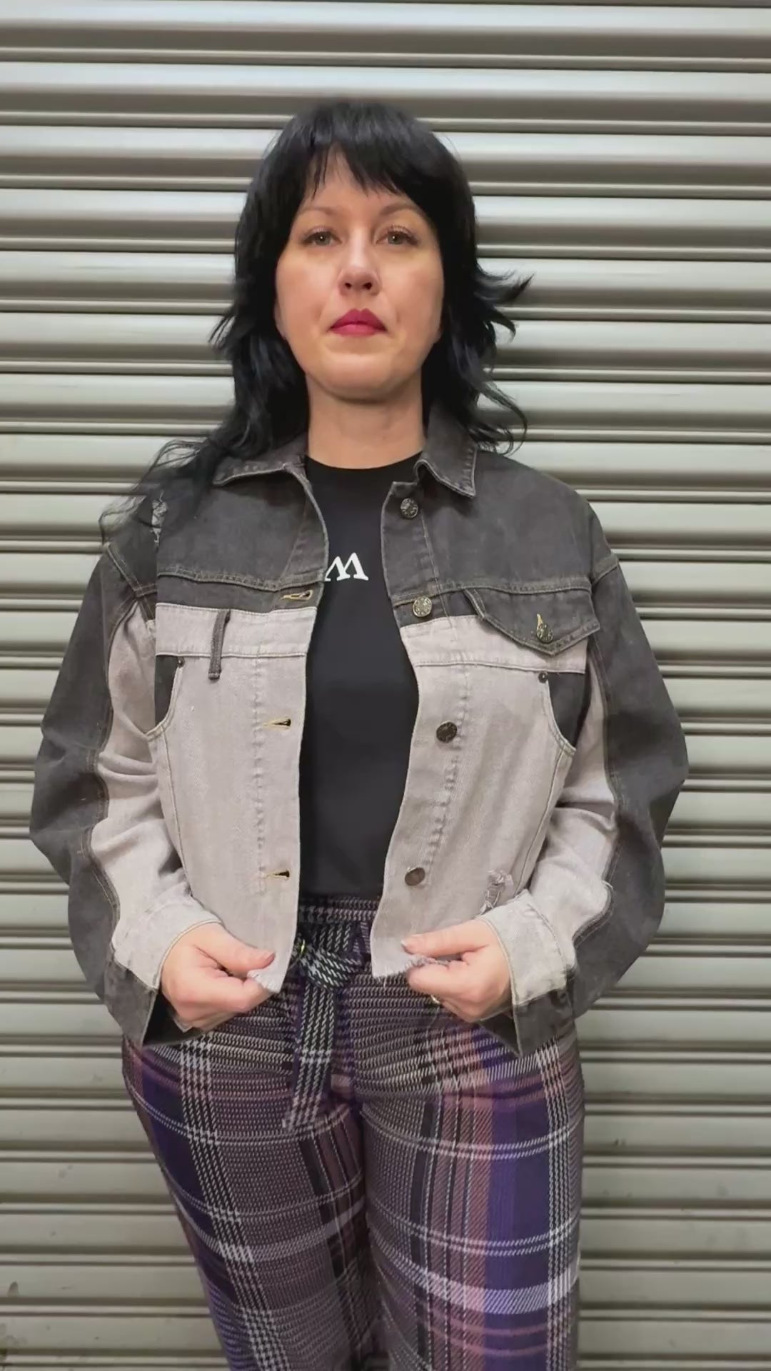 Women modeling split black and white denim jacket.