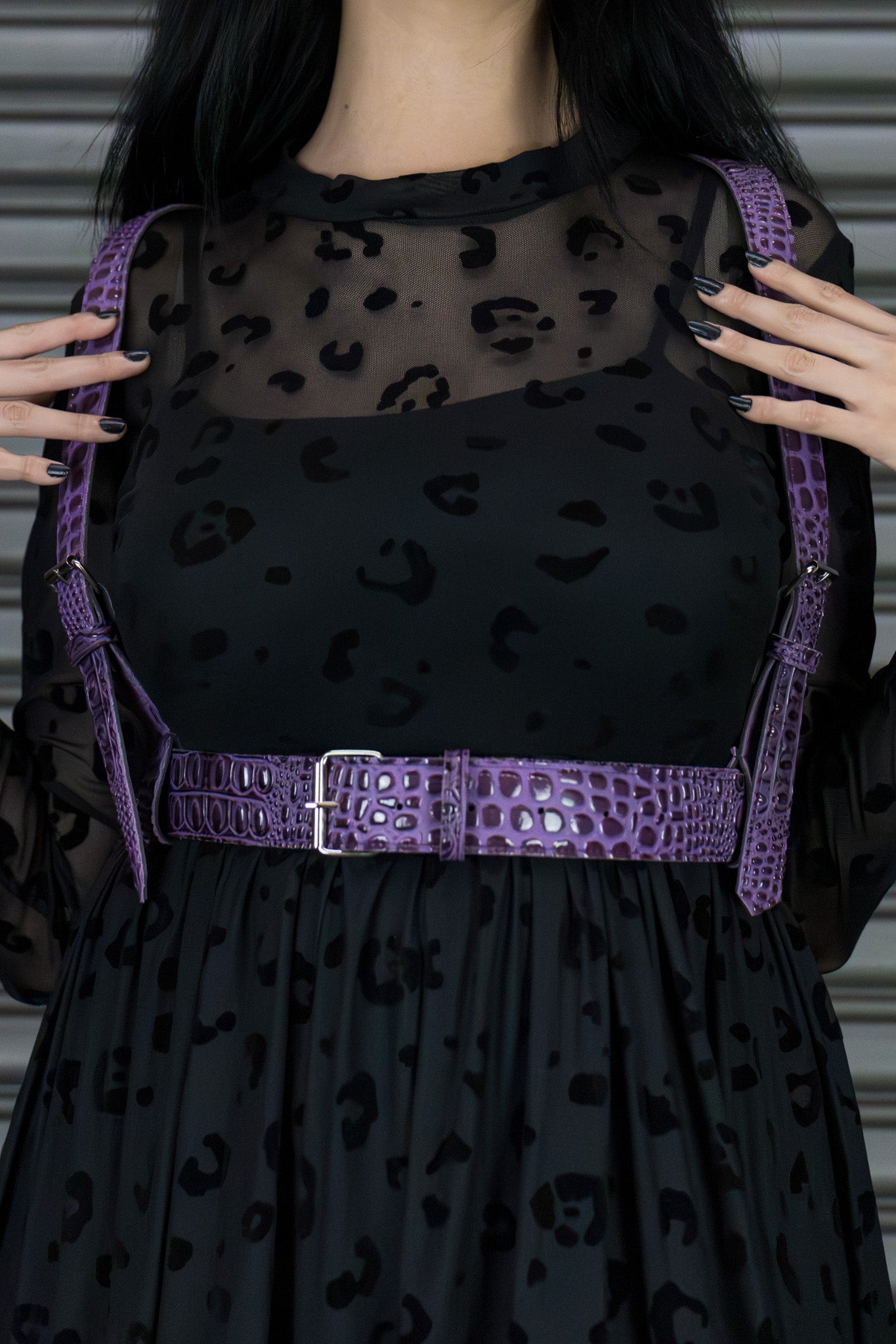 Black dress with purple leopard print and a purple harness worn by a person.