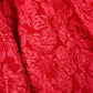 Red textured fabric with a floral pattern