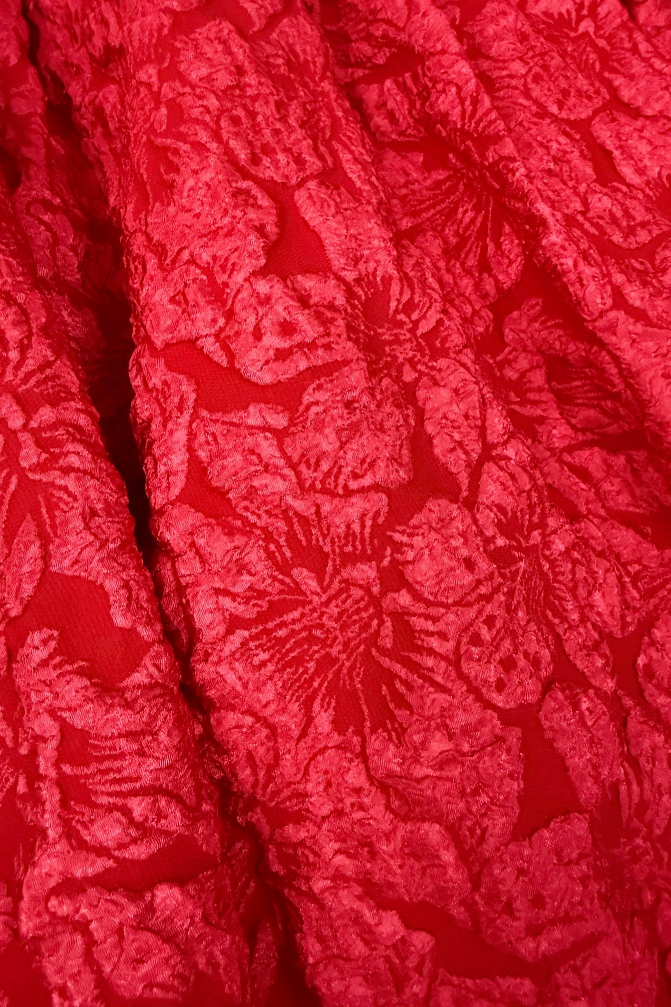 Red textured fabric with a floral pattern