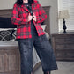 Person wearing a red plaid jacket in a bedroom setting
