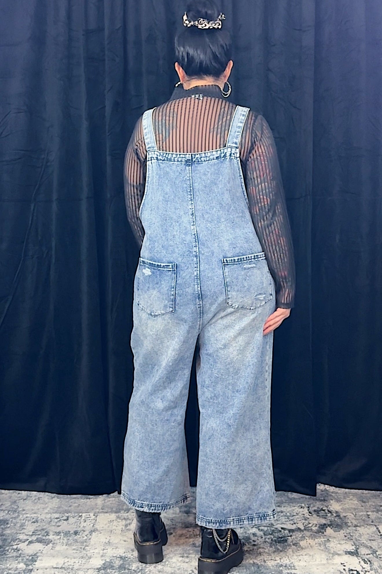 women in striped top wearing light blue overalls