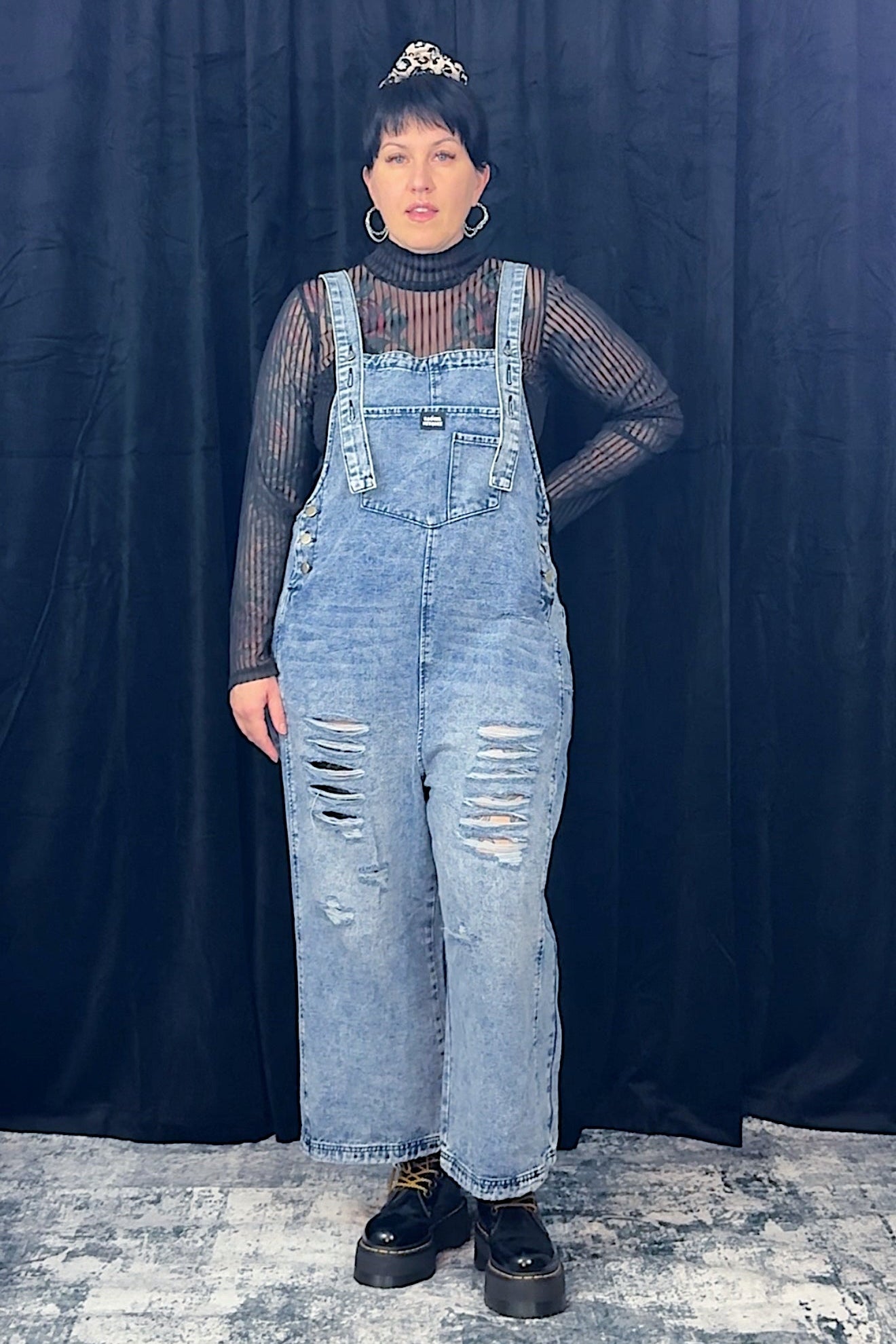women in striped top wearing light blue overalls