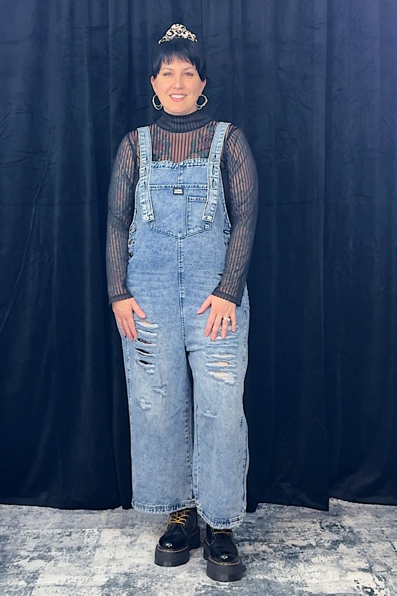 women in striped top wearing light blue overalls