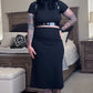 Person wearing a black outfit in a bedroom