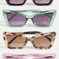 Four pairs of cat-eye sunglasses in different colors on a white background