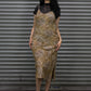 Woman wearing a leopard print dress with a black top against a metal shutter background