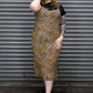 Person wearing a leopard print dress in front of a metal shutter.
