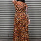 Person wearing a leopard print dress standing in front of a metal shutter.
