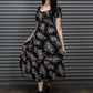 Woman wearing a floral dress standing in front of a metallic shutter.