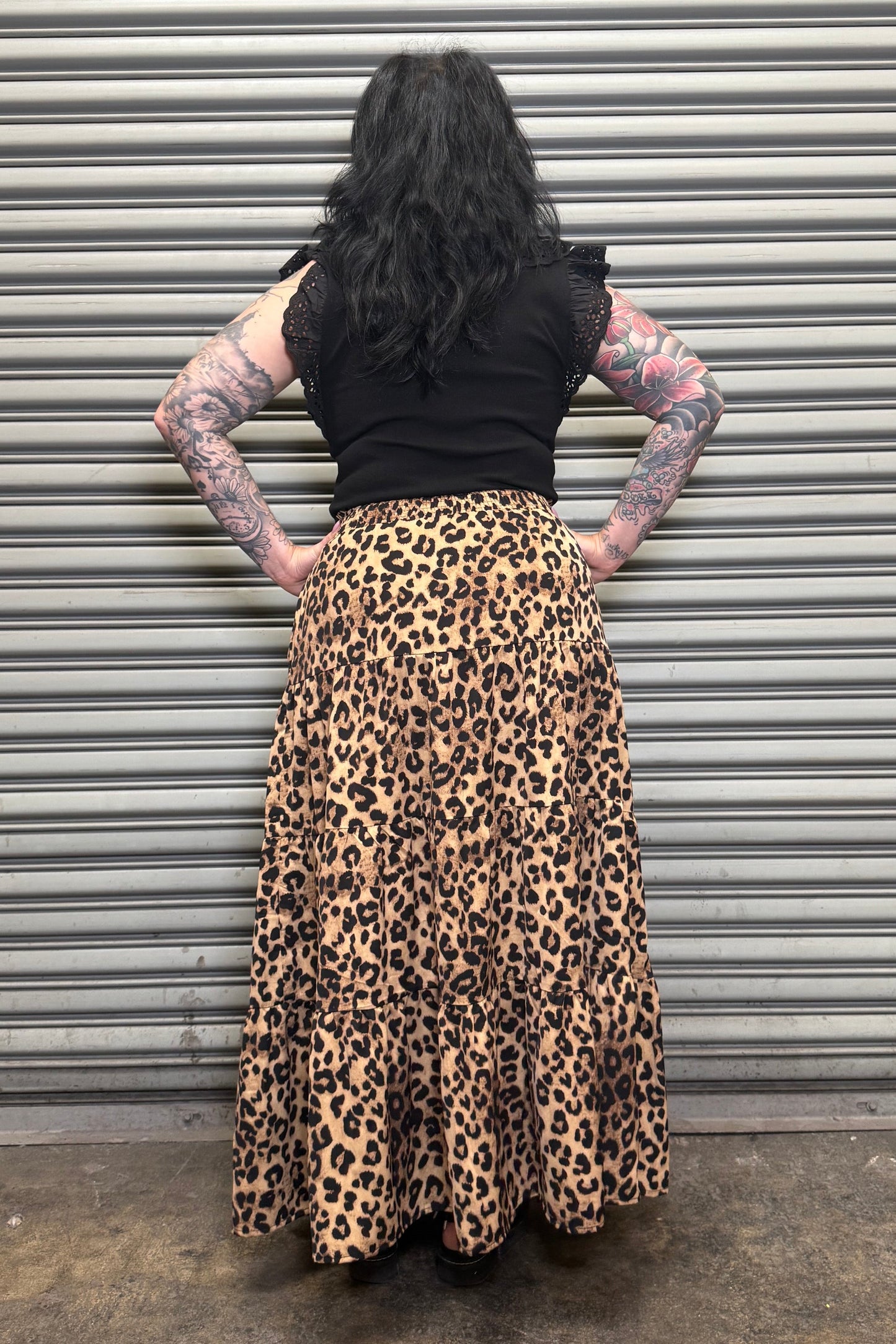Back view of the Wild Heart leopard print tiered maxi skirt showing the flowy design and comfortable waistband.