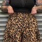 Detail view of the Wild Heart leopard print tiered maxi skirt showing the elastic waistband and leopard print fabric.