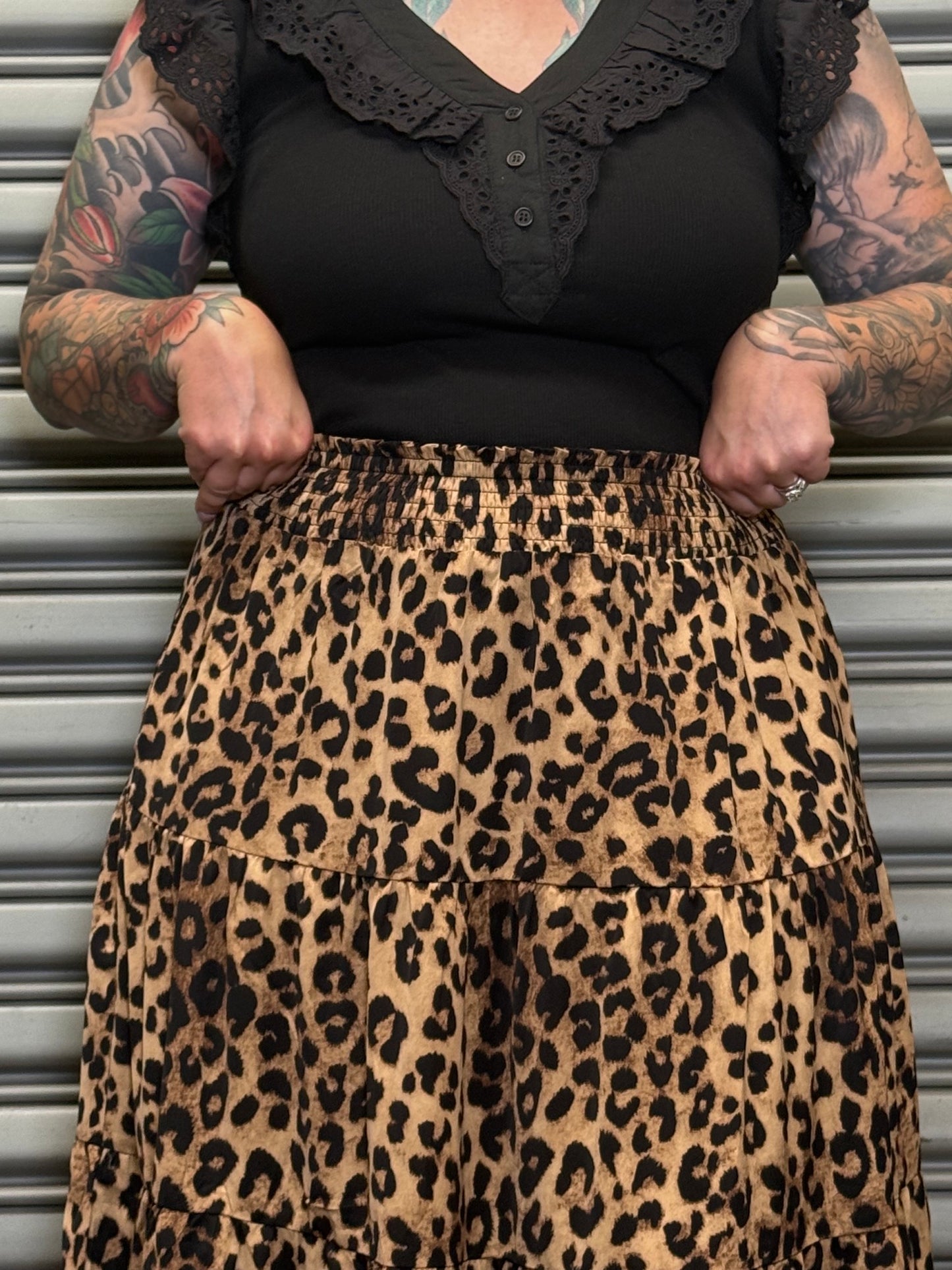 Detail view of the Wild Heart leopard print tiered maxi skirt showing the elastic waistband and leopard print fabric.