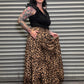 Side view of the Wild Heart leopard print tiered maxi skirt with pockets and flowing silhouette.