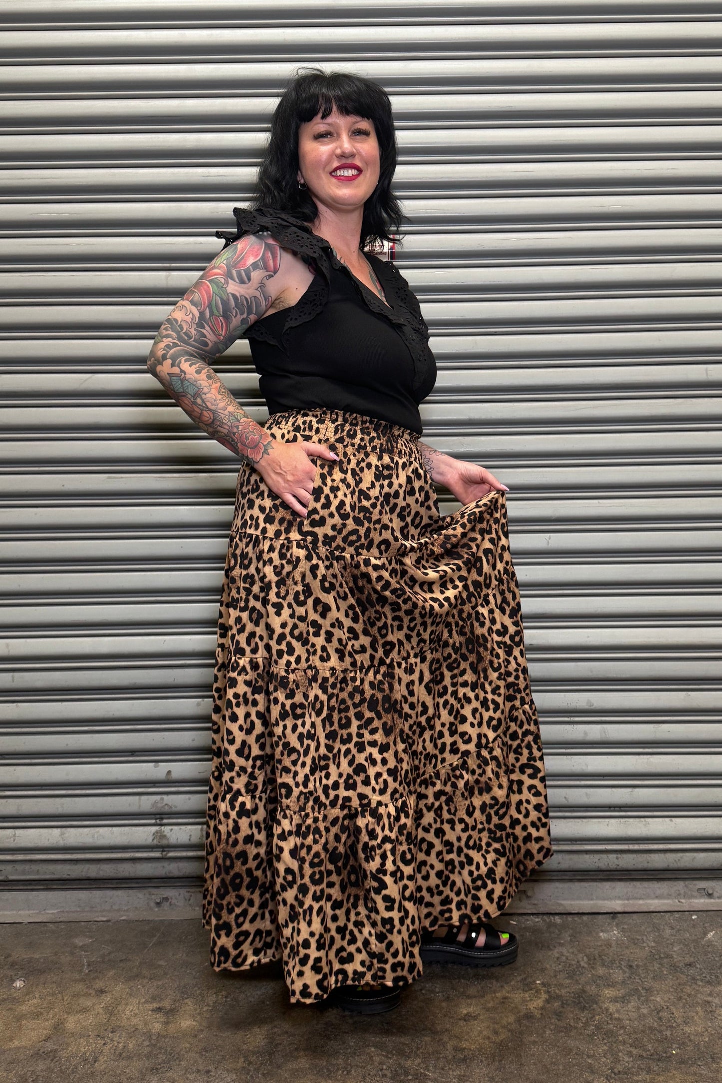 Side view of the Wild Heart leopard print tiered maxi skirt with pockets and flowing silhouette.