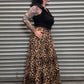 Side view of the Wild Heart leopard print tiered maxi skirt showing the flowy silhouette and pocket detail.