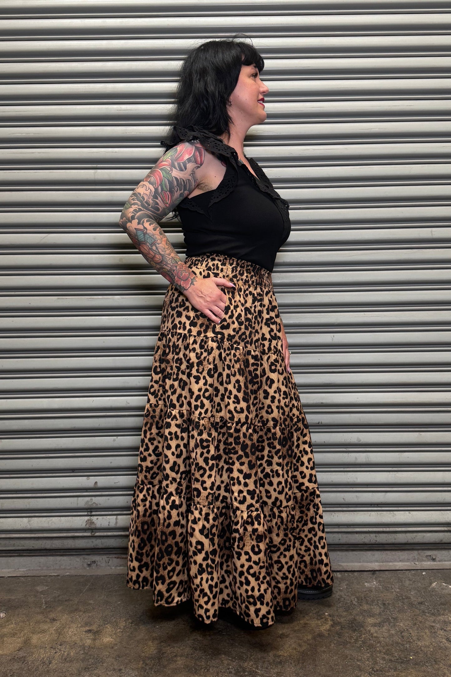 Side view of the Wild Heart leopard print tiered maxi skirt showing the flowy silhouette and pocket detail.